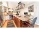 Modern kitchen with stainless steel appliances, granite countertops, breakfast bar, and custom built-in cabinets at 6964 S Olive Way, Centennial, CO 80112