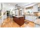 Open kitchen design with a large island, breakfast bar, stainless steel appliances, and custom cabinetry at 6964 S Olive Way, Centennial, CO 80112