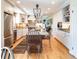 Well-appointed kitchen with stainless steel appliances, custom cabinetry, granite countertops, and hardwood flooring at 6964 S Olive Way, Centennial, CO 80112