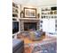 Living room showcasing brick fireplace, built-in shelving, and hardwood floors at 6964 S Olive Way, Centennial, CO 80112