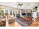 Cozy living room with a brick fireplace, built-in shelving, and french doors leading to the backyard at 6964 S Olive Way, Centennial, CO 80112