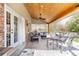 Outdoor patio area with wooden ceiling and outdoor dining furniture at 6964 S Olive Way, Centennial, CO 80112