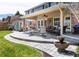 Covered patio features an outdoor kitchen and seating area at 6964 S Olive Way, Centennial, CO 80112