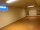 Bright basement space featuring laminate flooring and a large window at 598 Toledo St, Aurora, CO 80011