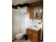 Small bathroom featuring wood vanity, medicine cabinet, and toilet at 598 Toledo St, Aurora, CO 80011