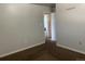 Bedroom with neutral paint, brown carpet, and a doorway leading to an attached bathroom at 598 Toledo St, Aurora, CO 80011