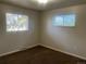 Bright bedroom with two windows and plush carpet flooring at 598 Toledo St, Aurora, CO 80011