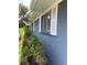 Exterior side shot showcasing the blue painted brick and white trim at 598 Toledo St, Aurora, CO 80011