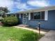 Charming blue brick home featuring well-kept lawn and decorative shutters at 598 Toledo St, Aurora, CO 80011