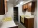 Vintage kitchen features a yellow sink and stove, along with ample cabinet space at 598 Toledo St, Aurora, CO 80011