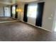 Open-concept living room with a mirrored wall and view of the outdoors at 598 Toledo St, Aurora, CO 80011
