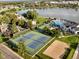 Aerial view of community with pool, tennis and volleyball courts, and lake at 1007 Thorncreek Ct, Thornton, CO 80241