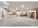 Spacious basement features recessed lighting, carpeted floors, and game area with bar at 1007 Thorncreek Ct, Thornton, CO 80241