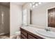 Bathroom with tiled countertop, a large mirror, and a walk-in shower at 1007 Thorncreek Ct, Thornton, CO 80241