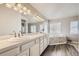 Bright bathroom with dual sinks, soaking tub, white cabinets, and modern finishes offers a relaxing retreat at 1007 Thorncreek Ct, Thornton, CO 80241