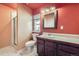 Bathroom features a shower, toilet, vanity with sink, and bright window with natural light at 1007 Thorncreek Ct, Thornton, CO 80241