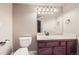 Bathroom features a toilet, vanity, and large mirror at 1007 Thorncreek Ct, Thornton, CO 80241