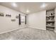 Bedroom features a window with blue curtains, light gray walls, carpeted floors, and shelving at 1007 Thorncreek Ct, Thornton, CO 80241