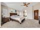 Bedroom with vaulted ceiling, ceiling fan, and a view to the ensuite bath at 1007 Thorncreek Ct, Thornton, CO 80241