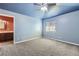 Spacious bedroom with light blue walls and carpeted flooring; features attached ensuite bathroom at 1007 Thorncreek Ct, Thornton, CO 80241