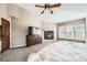Bedroom features a fireplace, a television, and large windows at 1007 Thorncreek Ct, Thornton, CO 80241