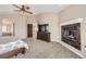 Bedroom showcasing a fireplace, television, and access to a spacious bathroom at 1007 Thorncreek Ct, Thornton, CO 80241