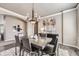 Elegant dining room featuring a stylish chandelier, neutral walls, and seating for six at 1007 Thorncreek Ct, Thornton, CO 80241