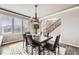 Elegant dining room showcases modern chandelier, large table and views to the entry at 1007 Thorncreek Ct, Thornton, CO 80241