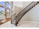 Welcoming foyer featuring tile floors, a grand staircase, and a wooden front door with glass inserts at 1007 Thorncreek Ct, Thornton, CO 80241