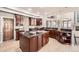 Expansive kitchen showcasing rich wood cabinets, countertop space and stairs to upper floor at 1007 Thorncreek Ct, Thornton, CO 80241