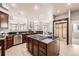 Open kitchen with stainless steel appliances, an island cooktop, and seamless flow into living spaces at 1007 Thorncreek Ct, Thornton, CO 80241