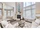 Cozy living room with fireplace, neutral decor, and large windows for natural light at 1007 Thorncreek Ct, Thornton, CO 80241