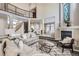 Bright living room with fireplace, large columns, second story balcony, and lots of natural light at 1007 Thorncreek Ct, Thornton, CO 80241