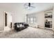 Cozy living room with carpet, a window, and built-in shelving; featuring a comfortable sofa at 1007 Thorncreek Ct, Thornton, CO 80241