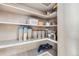 Walk-in pantry with white shelving filled with food items and household supplies at 1007 Thorncreek Ct, Thornton, CO 80241