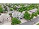 Aerial view of the house showcasing its spacious driveway, professional landscaping, and mature trees at 9468 E Aspen Hill Ln, Lone Tree, CO 80124