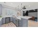 Bar with stainless steel dishwasher, white countertop, and adjacent theatre room at 9468 E Aspen Hill Ln, Lone Tree, CO 80124