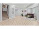Finished basement features neutral walls, wood-look flooring, and comfortable seating at 9468 E Aspen Hill Ln, Lone Tree, CO 80124