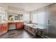 Bright bathroom with dual sinks, a sleek vanity, soaking tub with decorative stone surround, and a glass-enclosed shower at 9468 E Aspen Hill Ln, Lone Tree, CO 80124