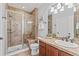 Beautiful bathroom featuring a glass shower, tile flooring, and a vanity with stone countertops at 9468 E Aspen Hill Ln, Lone Tree, CO 80124