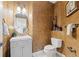 Powder room featuring textured walls, a vessel sink, decorative mirror, and modern fixtures at 9468 E Aspen Hill Ln, Lone Tree, CO 80124