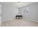 Light-filled bedroom with shutters, wood-look flooring, and minimalist furnishings at 9468 E Aspen Hill Ln, Lone Tree, CO 80124