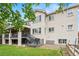 Rear exterior view of a two-story house with a deck, patio, lawn, and garden at 9468 E Aspen Hill Ln, Lone Tree, CO 80124