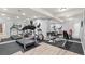 Finished basement gym features workout machines, mirrors, and hardwood flooring at 9468 E Aspen Hill Ln, Lone Tree, CO 80124