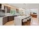 Open kitchen with island seating, custom cabinetry, and open layout at 9468 E Aspen Hill Ln, Lone Tree, CO 80124