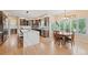Kitchen features an island with a quartz countertop and a breakfast nook with large windows at 9468 E Aspen Hill Ln, Lone Tree, CO 80124