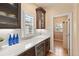 Kitchen with a wine cooler, quartz countertop, white backsplash, and dark wood cabinets at 9468 E Aspen Hill Ln, Lone Tree, CO 80124
