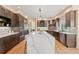 Spacious kitchen featuring a large quartz island and custom cabinetry at 9468 E Aspen Hill Ln, Lone Tree, CO 80124