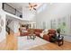 Open-concept living room with high ceilings, lots of windows, and a comfortable sectional sofa at 9468 E Aspen Hill Ln, Lone Tree, CO 80124