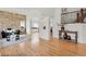 Bright living room featuring hardwood floors, stone accent wall and staircase at 9468 E Aspen Hill Ln, Lone Tree, CO 80124